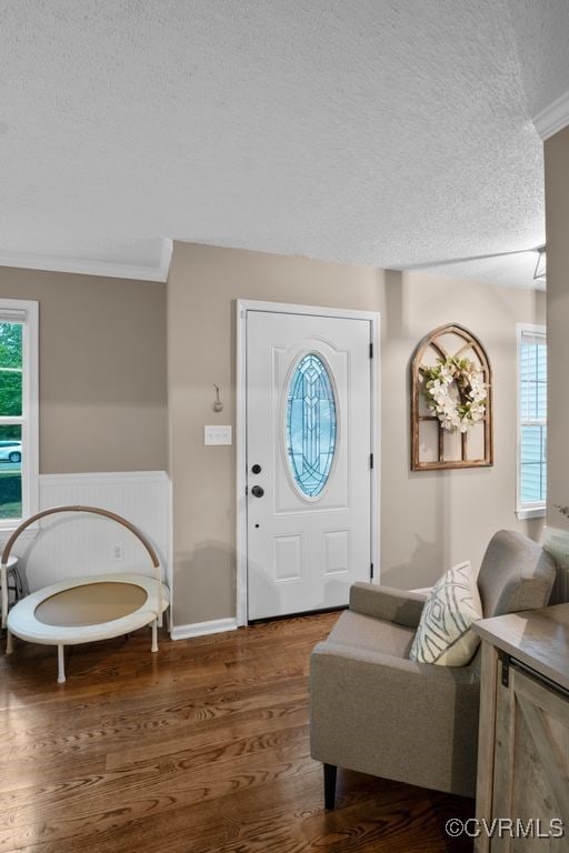 3190 Magnolia Woods Ter, New Kent, VA 23141 - foyer featuring a textured ceiling, wood finished floors, crown molding, plenty of natural light, and a wainscoted wall