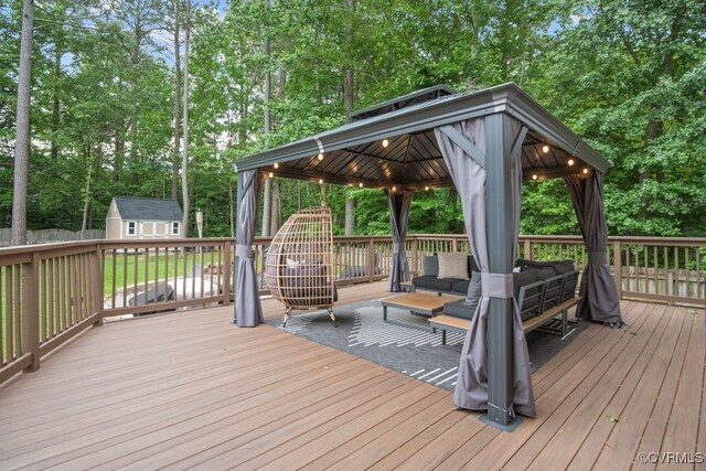 3190 Magnolia Woods Ter, New Kent, VA 23141 - wooden deck featuring an outdoor living space, a gazebo, view of scattered trees, a storage unit, and an outdoor structure