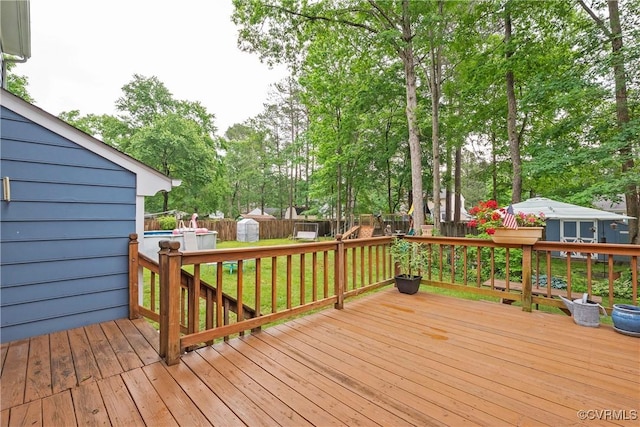 wooden terrace featuring view of wooded area