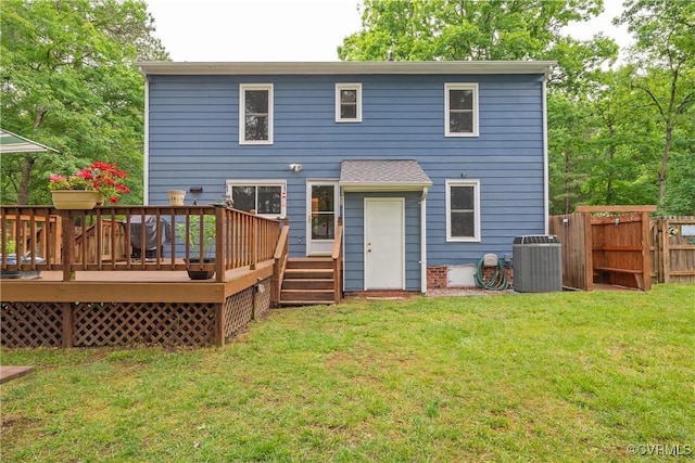 rear view of property featuring central AC and a wooden deck