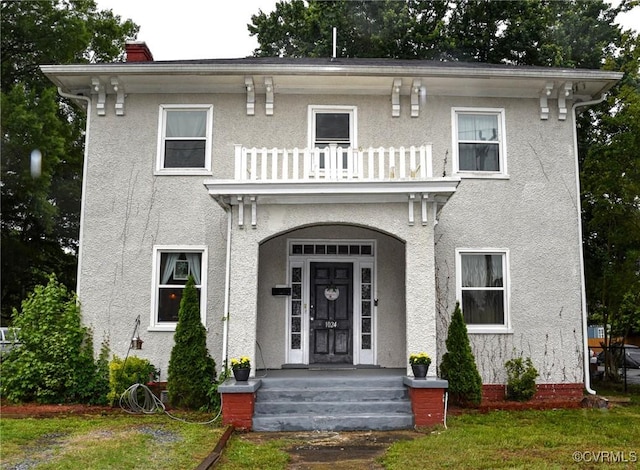 1024 W S Blvd, Petersburg, VA 23805 - italianate-style house with a balcony, stucco siding, and a chimney