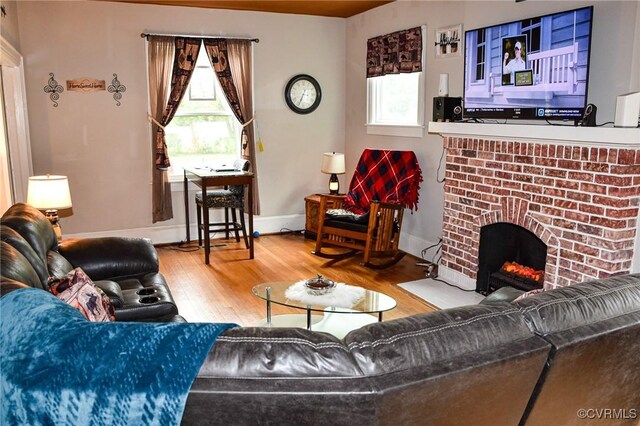 1024 W S Blvd, Petersburg, VA 23805 - living room featuring healthy amount of natural light, wood finished floors, a fireplace, and baseboards