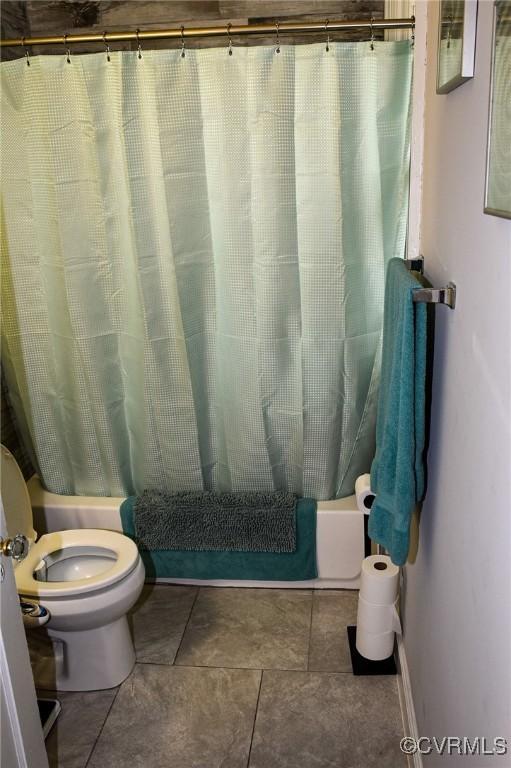 1024 W S Blvd, Petersburg, VA 23805 - bathroom with toilet, shower / tub combo with curtain, and tile patterned floors