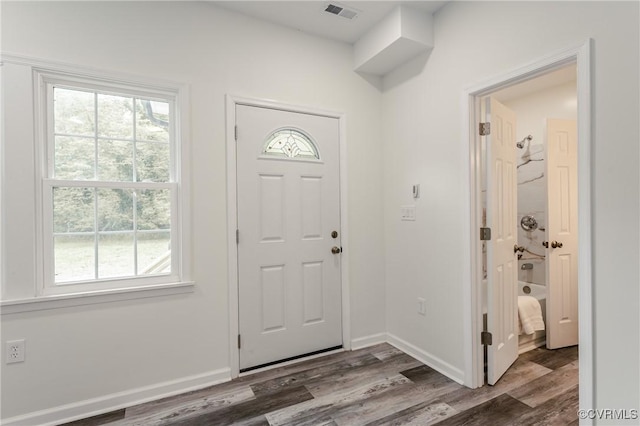 foyer entrance featuring wood finished floors and baseboards