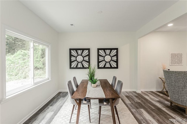 dining space featuring dark wood-type flooring, baseboards, and recessed lighting