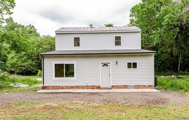 rear view of house featuring metal roof