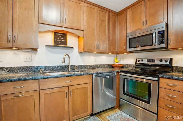 10808 Stanton Way, Henrico, VA 23238 - kitchen with appliances with stainless steel finishes, a sink, brown cabinetry, and light wood-style flooring