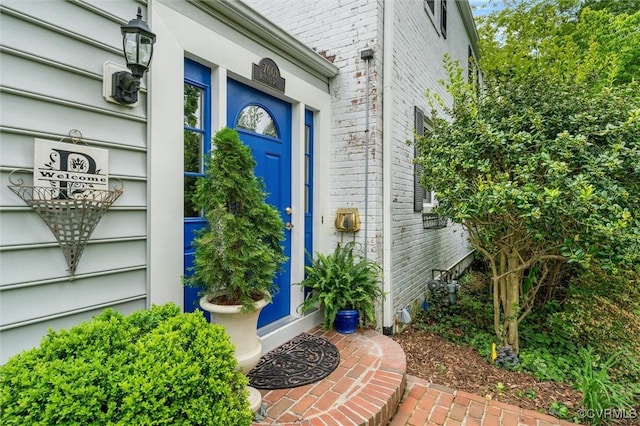 view of exterior entry with brick siding