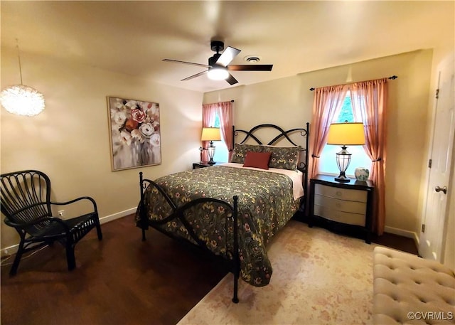 carpeted bedroom with baseboards and a ceiling fan