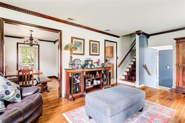 9301 Carlway Ct, Henrico, VA 23228 - living area featuring ornamental molding, a chandelier, light wood finished floors, stairs, and baseboards