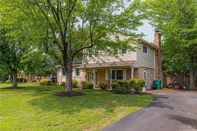 9301 Carlway Ct, Henrico, VA 23228 - traditional-style home with a chimney, driveway, and brick siding