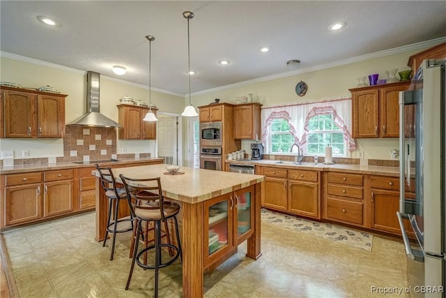 10402 Freewelcome Ln, Gloucester, VA 23050 - kitchen with wall chimney exhaust hood, a sink, stainless steel appliances, brown cabinets, and crown molding