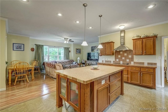 10402 Freewelcome Ln, Gloucester, VA 23050 - kitchen with wall chimney range hood, black electric stovetop, crown molding, brown cabinets, and light countertops