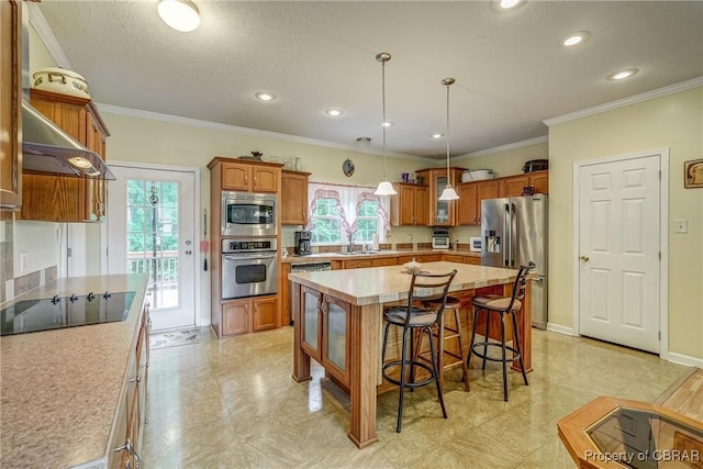 10402 Freewelcome Ln, Gloucester, VA 23050 - kitchen with stainless steel appliances, brown cabinetry, a sink, a breakfast bar, and light countertops