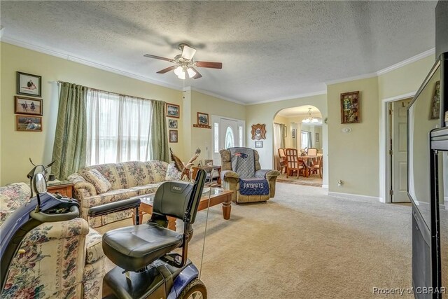 10402 Freewelcome Ln, Gloucester, VA 23050 - carpeted living room with arched walkways, ornamental molding, a textured ceiling, ceiling fan, and baseboards