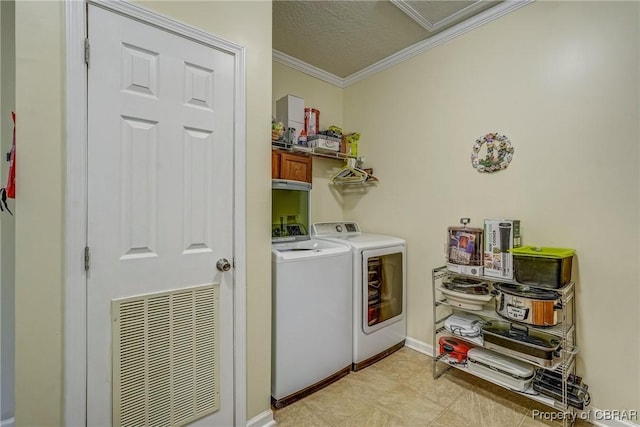 10402 Freewelcome Ln, Gloucester, VA 23050 - laundry area with washing machine and clothes dryer, crown molding, and a textured ceiling