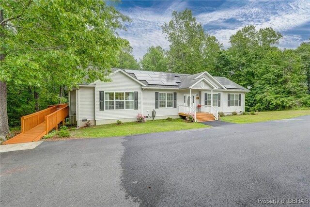 10402 Freewelcome Ln, Gloucester, VA 23050 - view of front of home featuring solar panels and a front yard