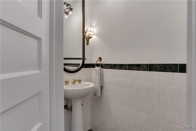 bathroom with tile walls