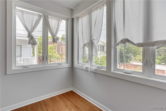 empty room with baseboards and wood finished floors