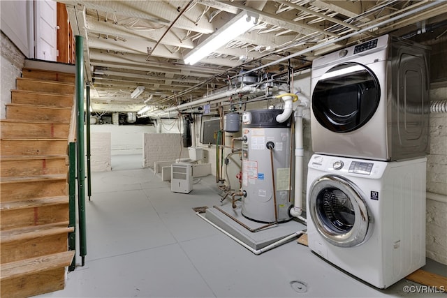 laundry room featuring stacked washer / dryer and water heater