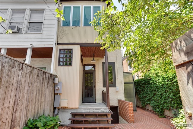 doorway to property featuring fence