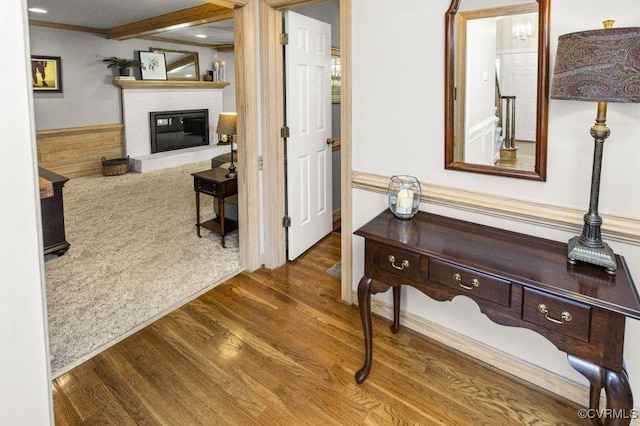 hall featuring wood finished floors and ornamental molding