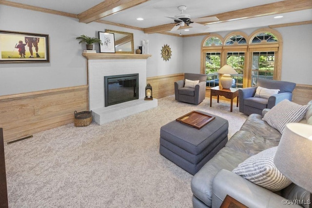 living room featuring beam ceiling, a fireplace, ceiling fan, recessed lighting, and carpet floors