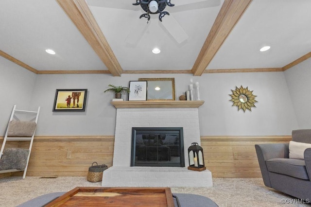 living room with beam ceiling, recessed lighting, crown molding, a brick fireplace, and a ceiling fan