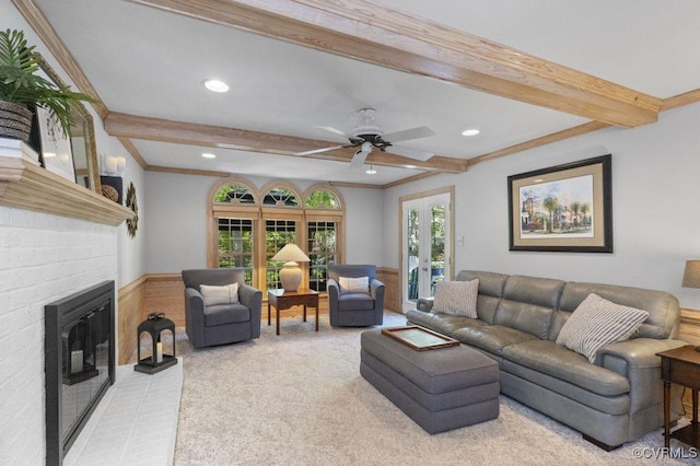 living room with beamed ceiling, light colored carpet, a fireplace, recessed lighting, and crown molding