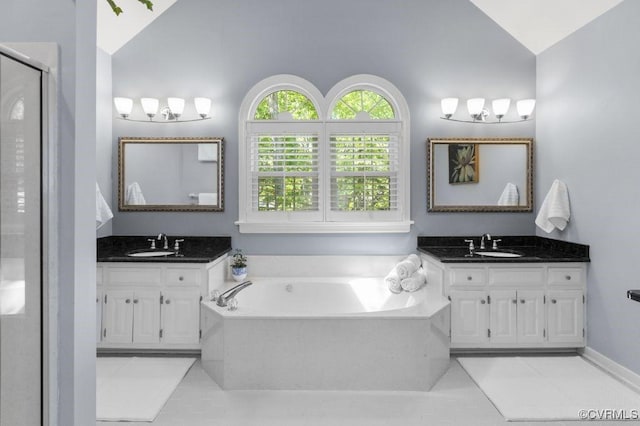 full bath featuring vaulted ceiling, tile patterned flooring, two vanities, a bath, and a stall shower