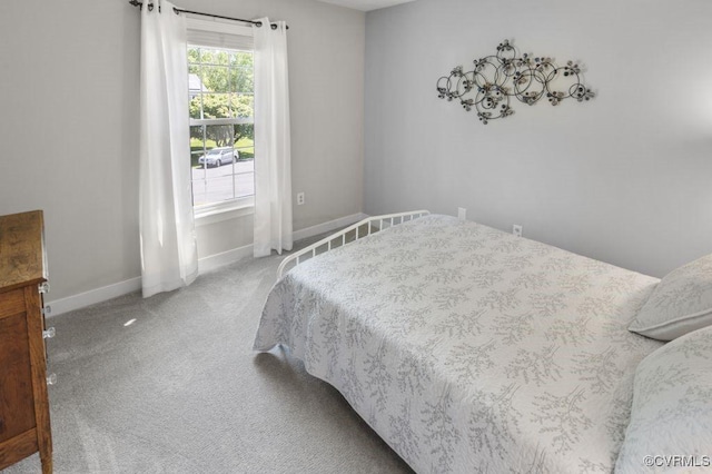 carpeted bedroom featuring baseboards