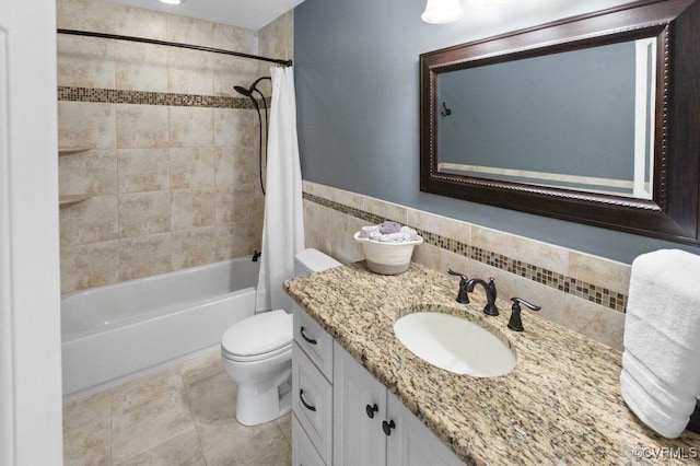 bathroom with shower / bath combination with curtain, toilet, vanity, tile walls, and tile patterned flooring