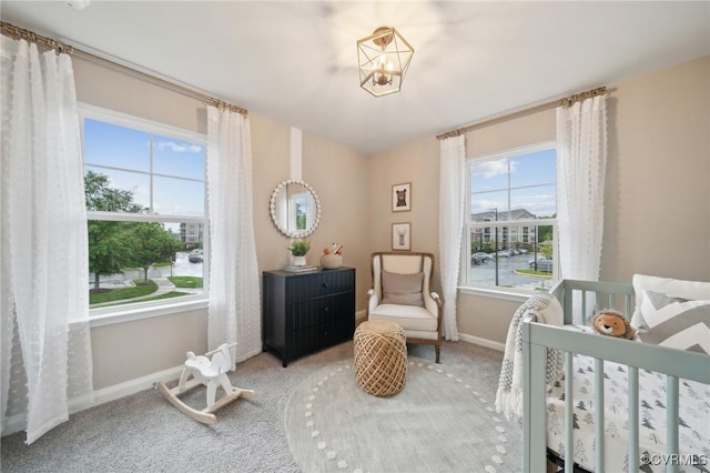 6008 Banyan Ln, Chesterfield, VA 23234 - carpeted bedroom with multiple windows, baseboards, and a chandelier