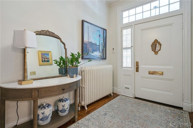 foyer entrance with radiator and wood finished floors