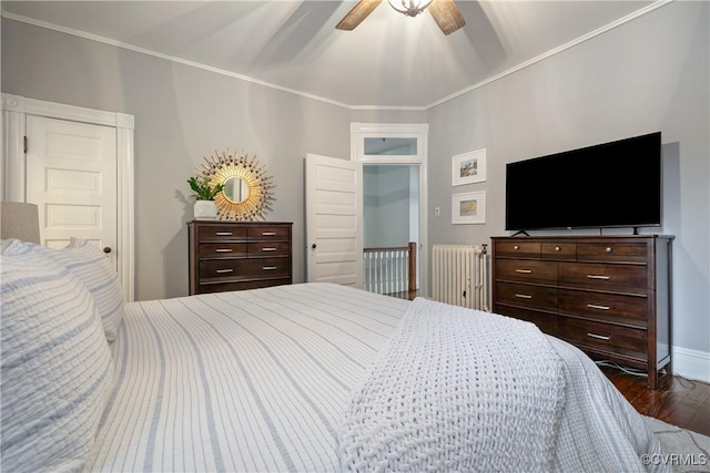 bedroom with wood finished floors, ornamental molding, a ceiling fan, and baseboards