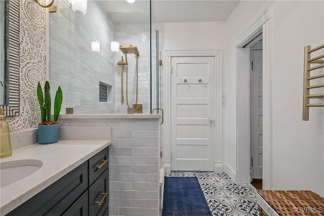 full bathroom with a stall shower, vanity, and tile patterned flooring
