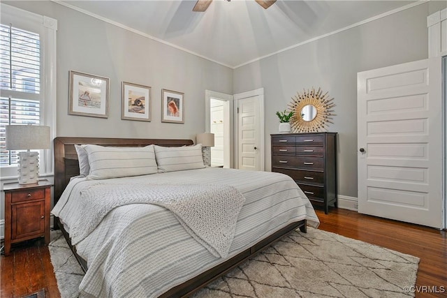 bedroom with ornamental molding, dark wood-style floors, baseboards, a closet, and a ceiling fan