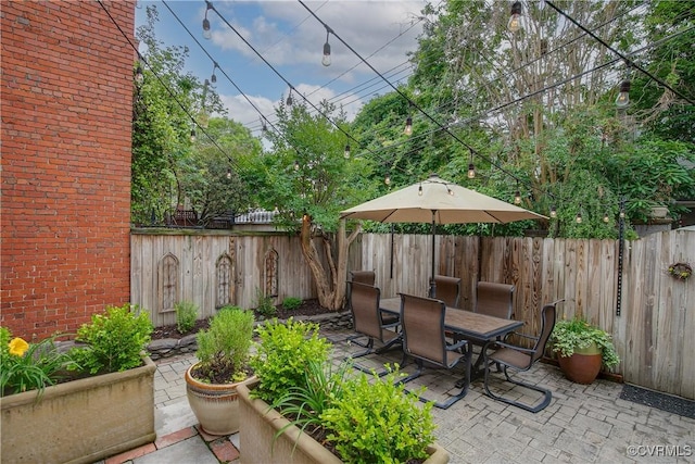 view of patio with outdoor dining area and a fenced backyard