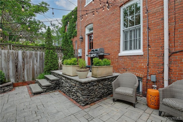 view of patio featuring fence and grilling area