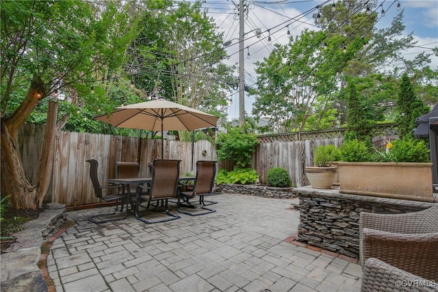 view of patio with outdoor dining space and a fenced backyard