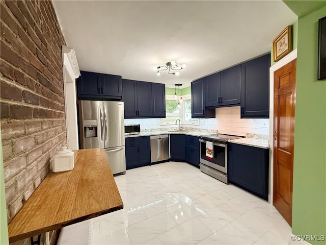 4210 Wistar Rd, Henrico, VA 23228 - kitchen with appliances with stainless steel finishes, light marble finish flooring, a sink, backsplash, and blue cabinetry