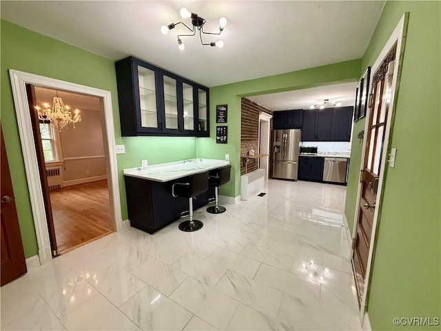 4210 Wistar Rd, Henrico, VA 23228 - kitchen with stainless steel appliances, a chandelier, radiator heating unit, glass insert cabinets, and light marble finish floors