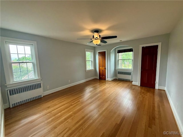 4210 Wistar Rd, Henrico, VA 23228 - unfurnished room with radiator, wood finished floors, baseboards, and arched walkways