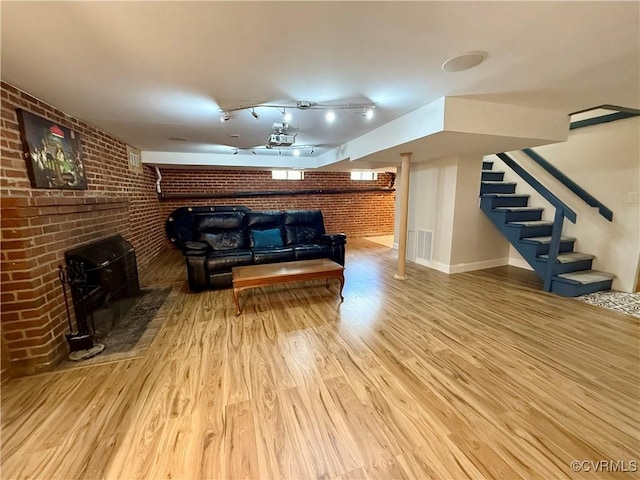 4210 Wistar Rd, Henrico, VA 23228 - living area featuring brick wall, wood finished floors, and stairs