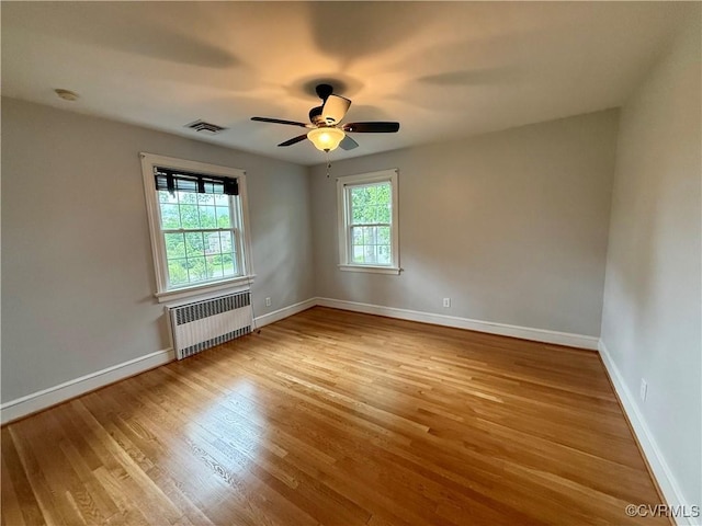 4210 Wistar Rd, Henrico, VA 23228 - unfurnished room featuring radiator heating unit, wood finished floors, ceiling fan, and baseboards