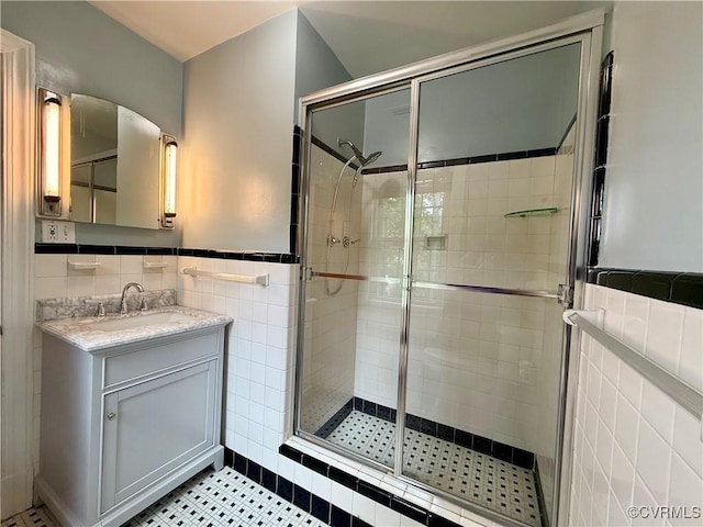 4210 Wistar Rd, Henrico, VA 23228 - full bath featuring tile walls, a stall shower, vanity, tile patterned floors, and a wainscoted wall
