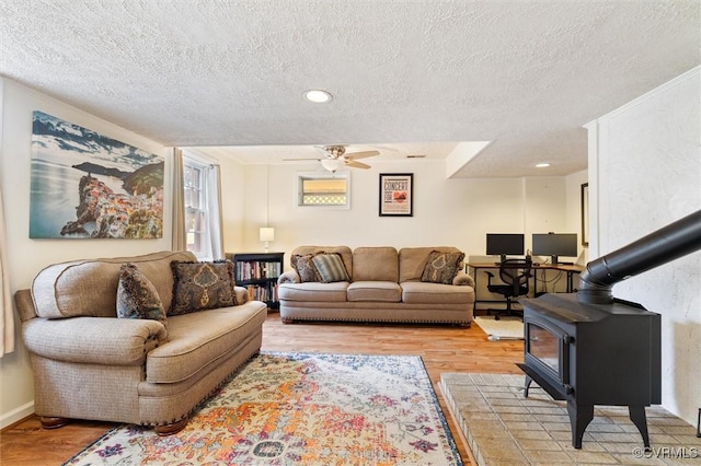 13 Bunker Blvd, Palmyra, VA 22963 - living room featuring a wood stove, light wood-style floors, a textured ceiling, and ceiling fan
