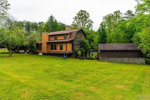 13 Bunker Blvd, Palmyra, VA 22963 - back of property with a chimney, a gambrel roof, and a lawn