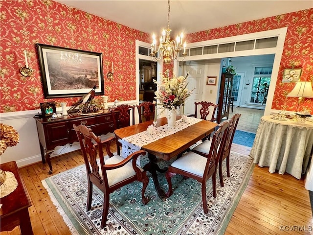 13300 Old Telegraph Rd, Providence Forge, VA 23140 - dining space with wallpapered walls, light wood-style flooring, a chandelier, and a wainscoted wall