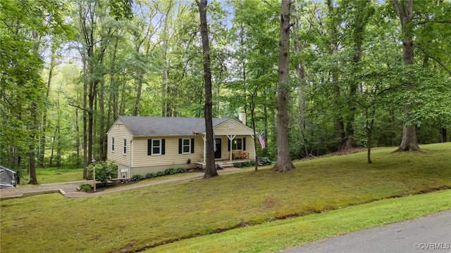 2465 W Deerpath Dr, Powhatan, VA 23139 - view of front facade featuring a front lawn, a chimney, and covered porch